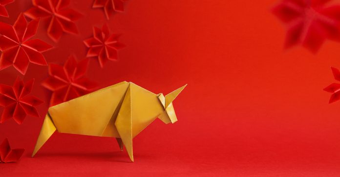 paper origami ox with red background