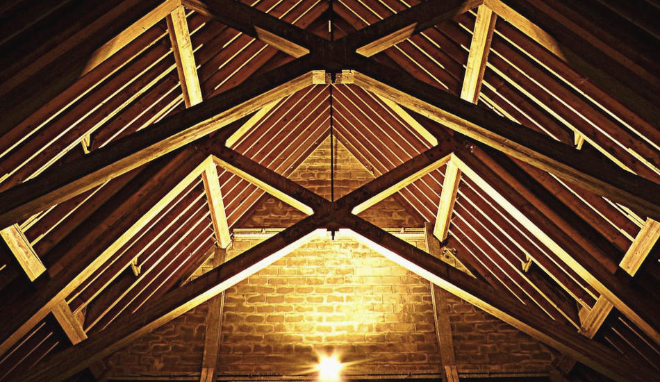Roof beams inside a brick building.