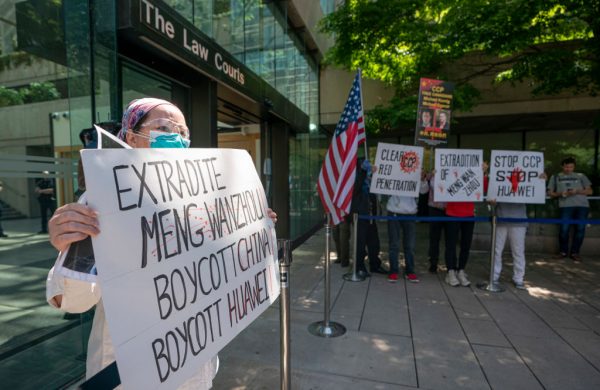 Protesters hold up a sign outside British Columbia Supreme Court where Meng Wanzhou attended a hearing on May 27, 2020 in Vancouver, Canada. Meng has been under house arrest in Vancouver for more than two years.
