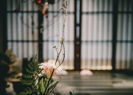 A 7-stringed guqin sits on an antique Chinese tea table.