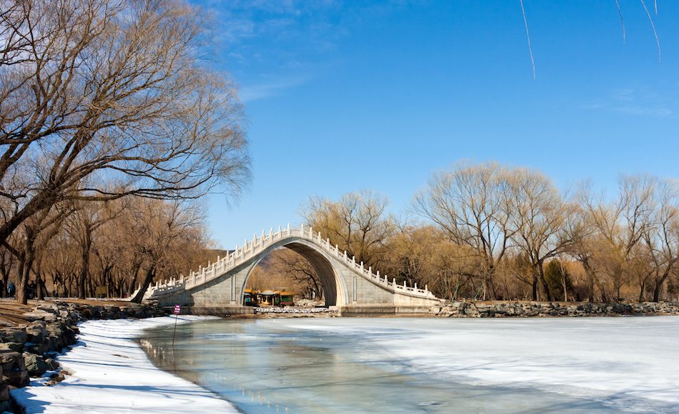 moon bridge from China over a frozen river on a winter day