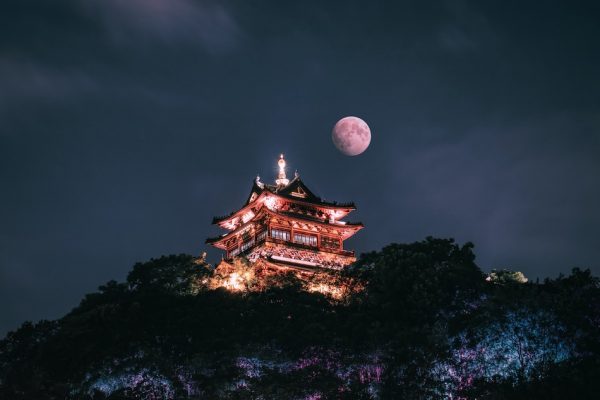 full moon above ancient chinese building at night