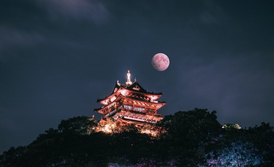 full moon above ancient chinese building at night