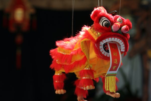 A lion dangling by a string on a market on Chinese New year, also known as the spring festival.