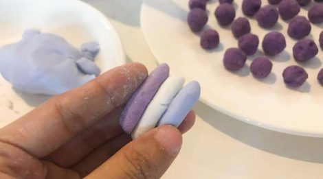 3 tubes of different colour held side by side in hand