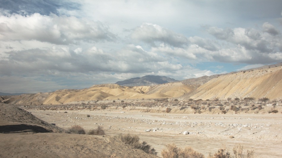 View looking towards Whale Peak, Anza Borrego National Park, dusty light brown soil mountains dry shrubs