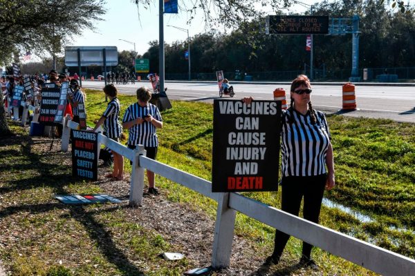 People protest against the covid-19 vaccine outside of the Raymond James Stadium prior to the Super Bowl match between Kansas City Chiefs and Tampa Bay Buccaneers in Tampa, Florida on February 7, 2021