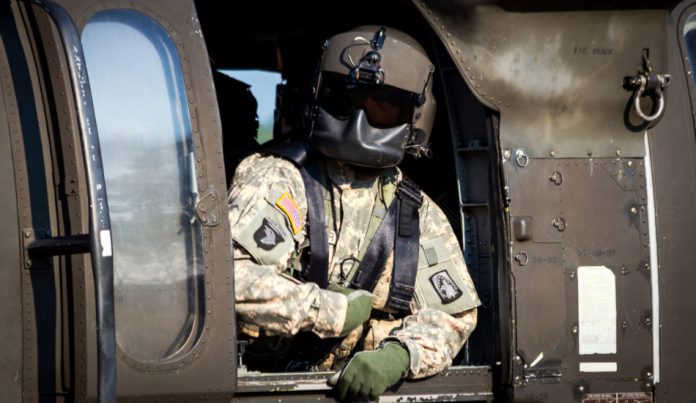 Crew chief in a US Army UH-60 Black Hawk helicopter.