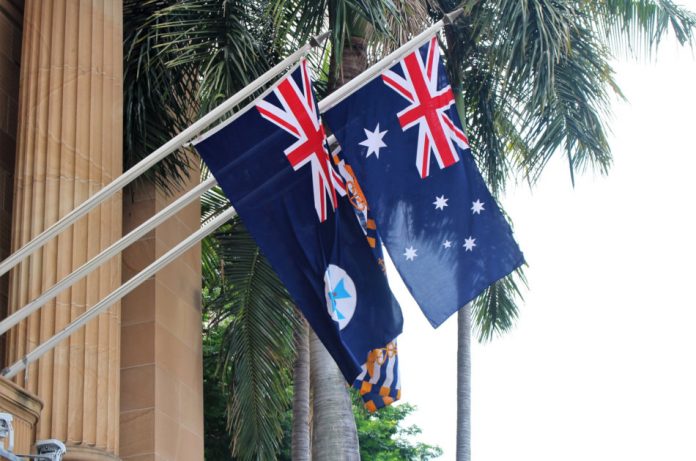 Queensland and Australia flag on a house wall in central Brisbane.
