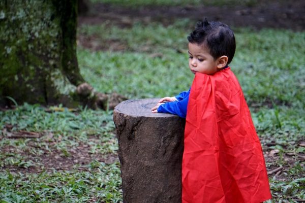 In make-believe play, a child who impersonates a superhero can play out and achieve goals, such as helping others and performing daring rescues.