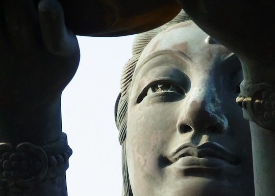 detail of statue bodhisattva Guan Yins face from large statue in Hong Kong