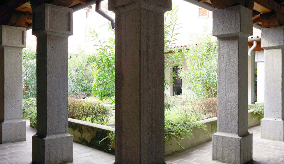 Architectural detail in Iseo, Italy, stone columns surrounding a courtyard.