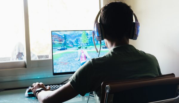 Teenager playing a video game on a PC.