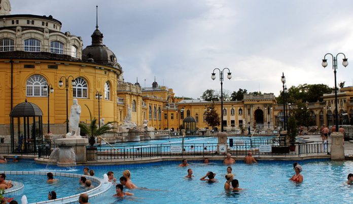 People in the water outside at the Budapest thermal spa Széchenyi Gyógyfürdő.