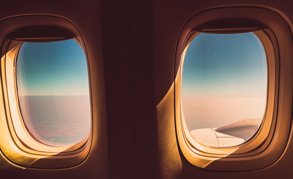 Looking out an airplane window while in flight from the seat just in front of the wing.