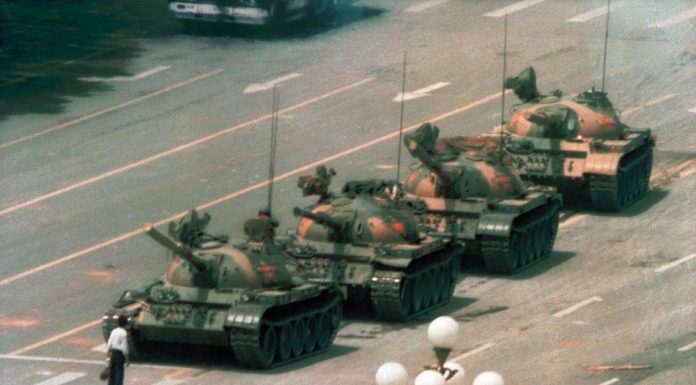 Image of the Tank Man, a lone individual standing in front of a line of tanks in Beijing in 1989.