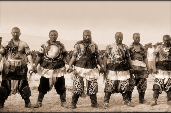 Black and white photo of six strong men dressed in ancient Chinese clothing.