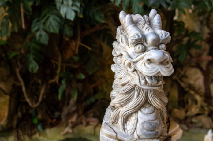 Statue of a Chinese dragon in a garden.