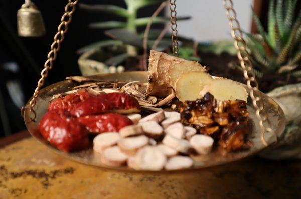 Ingredients for Chinese medicine being weighed out on a scale.