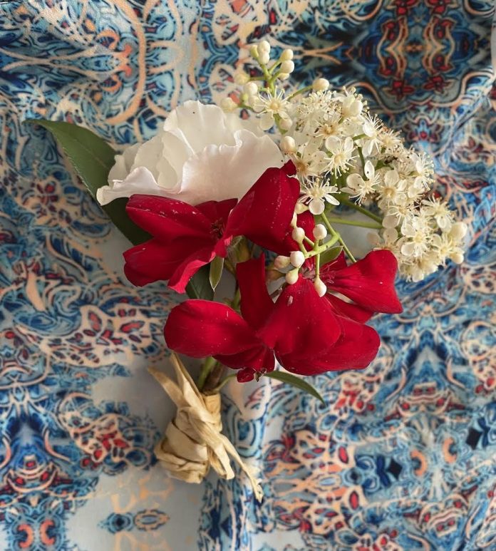 corsage red and white flowers on pattern table cloth
