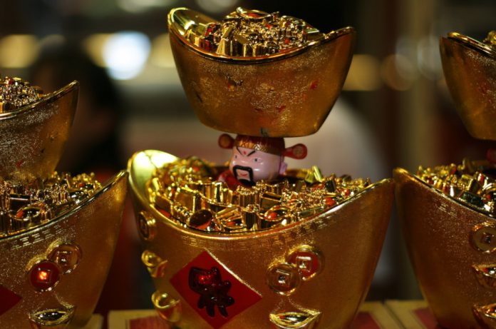 Display shaped like ancient Chinese gold ingots is filled with fake gold and rubies.