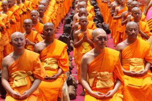 A large gathering of monks wearing orange robes.