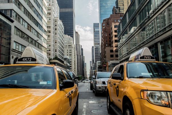 yellow taxi cabs in traffic 