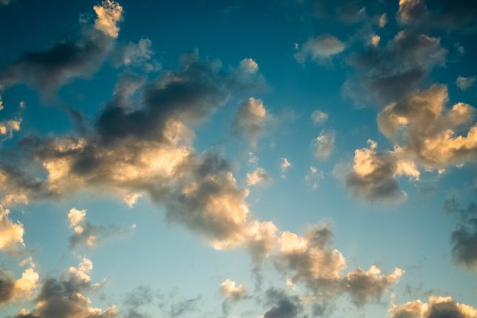 clouds in blue sky with sun hitting them
