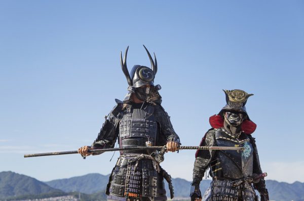 Two men dressed in Samurai armor at Itsukushima Shrine on Muyajima island, Japan.