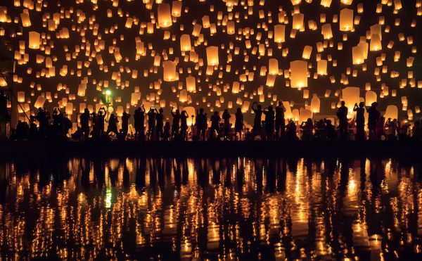 The warm orange glow of lanterns being sent up into the sky for the Yi Peng Festival in Chiang Mai, Thailand
