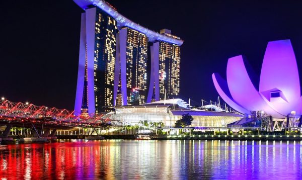 purple lights light up the art science museum building that looks like a large lotus flower