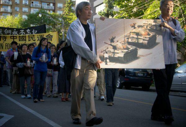 Memorial march to remember victims of the Tiananmen Massacre with people holding photos and candles.