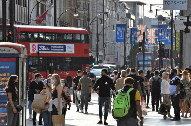 Crowd of people, some wearing protective face masks, on Oxford Street, London, United Kingdom in September 2020.