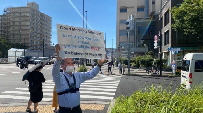 After standing outside the Tokyo Olympic Village for two hours every morning from July 22 to August 8 — the full duration of the Games — his motivational words truly made an impact.
