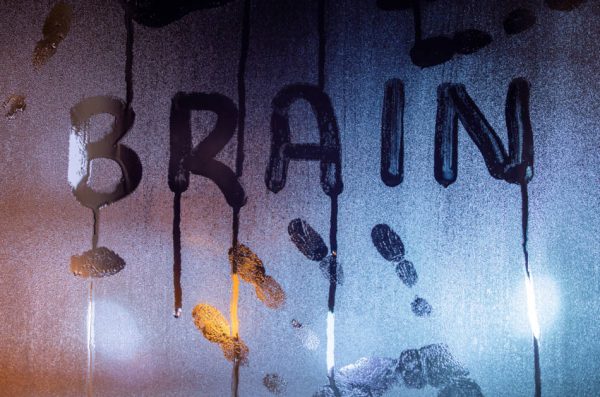 The word "brain" written on a window that has condensation on it. Concept for mental health, mental clutter.
