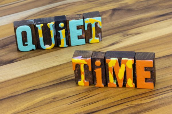 Block letters spelling out "quiet time", an essential tool for managing mental clutter.