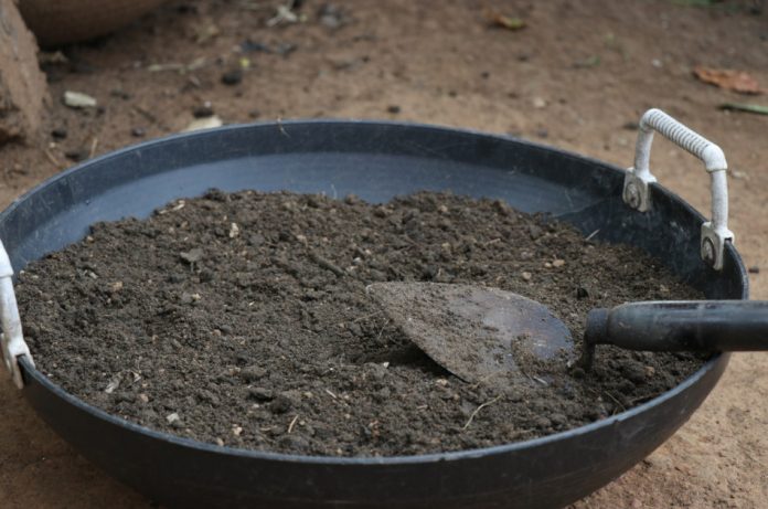 Potting soil with trowel in a basket.