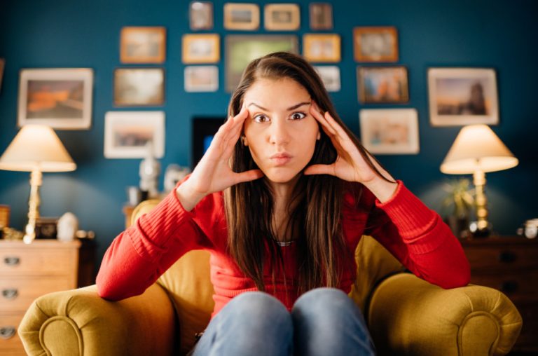 Woman stressing, overthinking events alone at home.