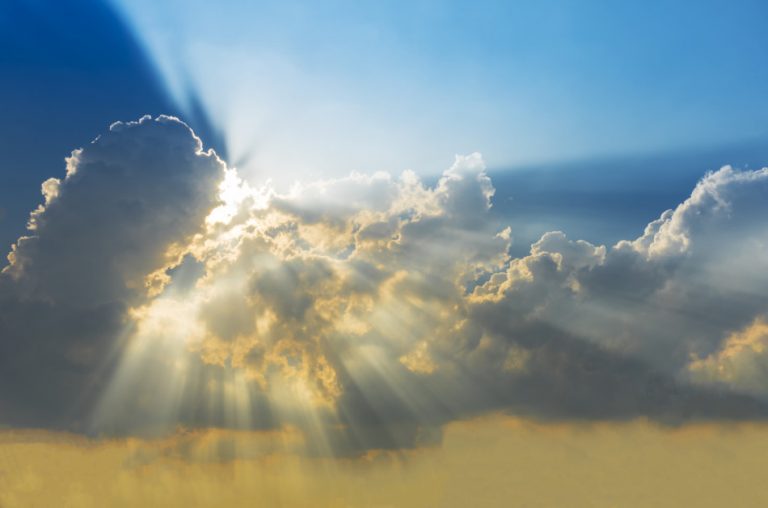 Rays of light from the sun shining through clouds.