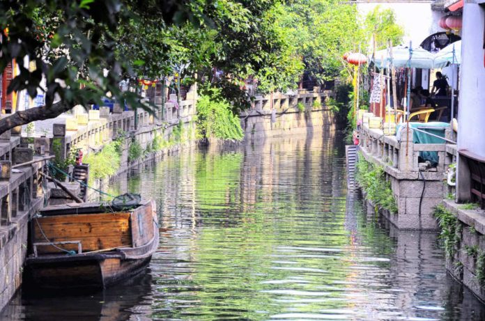 A tourist boat moored on the water canals within Tongli Town scenic area in Jiangsu Province China.