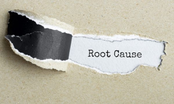 The text "Root Cause" appearing behind torn brown paper.