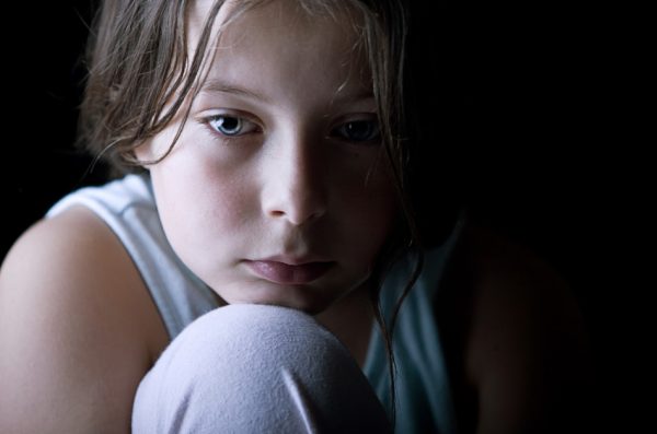 Young child looking sad.