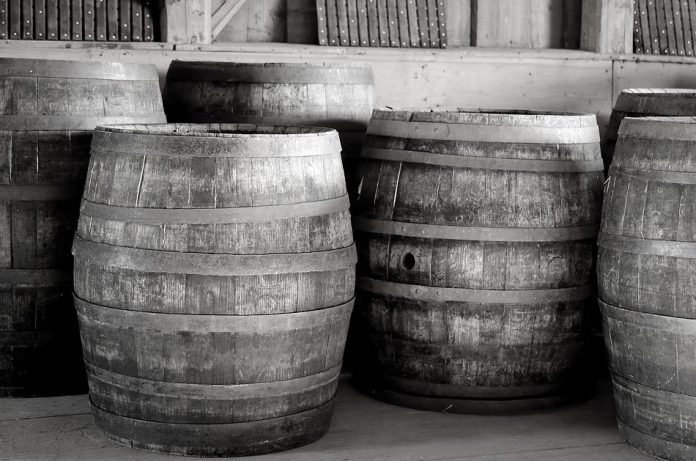 Black and white photo of wooden barrels.
