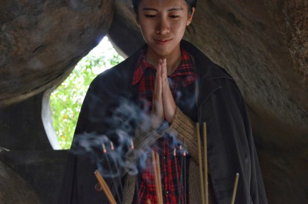 woman in a cave praying