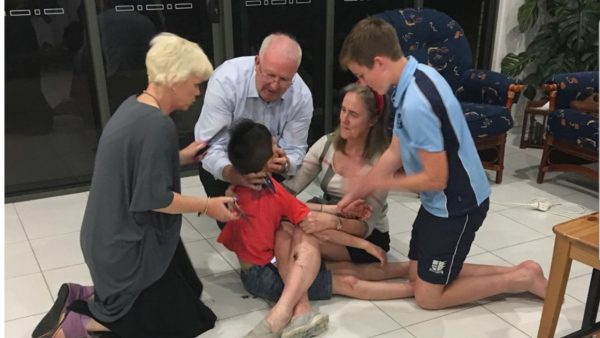 Jordie Rowland at home surrounded by his mother, father, and brother as Lisa Ann McKenzie tries to give him a haircut.