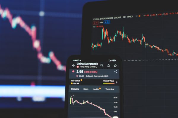 Evergrande on stock market screens on a laptop and a smartphone.
