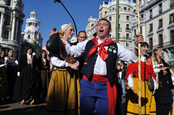People wearing traditional clothing on the streets of Madrid for Fiesta de la Trashumancia.
