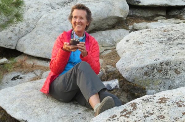 Dierdre Wolownick holds a cupcake with a candle in it after climbing to the top of El Capitan in Yosemite National Park.