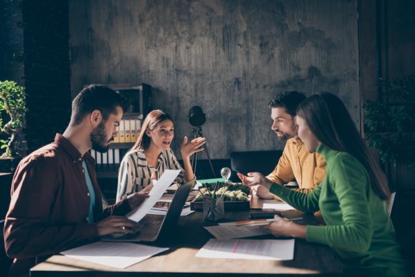 Men and women at a startup business meeting.