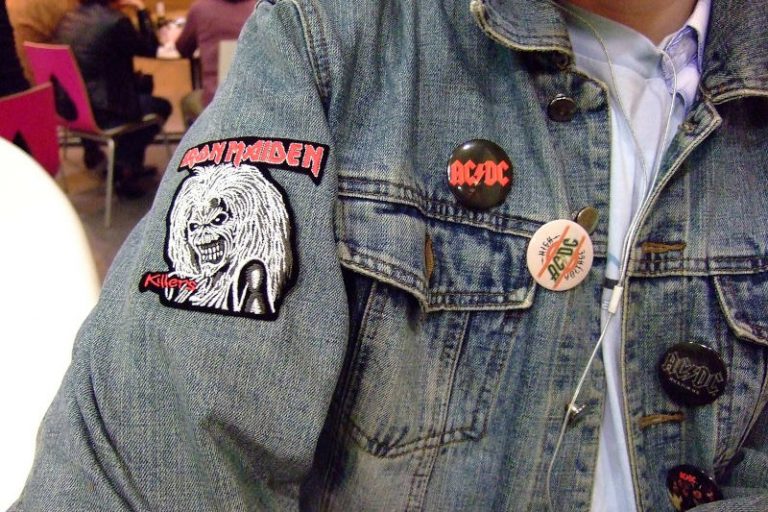 Heavy metal fan displaying his Iron Maiden patch and AC/DC buttons on an old faded jean jacket.